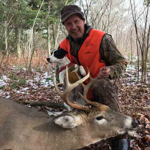 Two hunters showing their trophy after a day of whitetail deer hunting